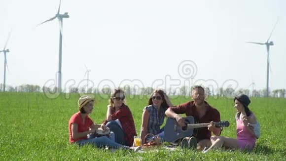 一群朋友在一片绿色的草地上安排了一次野餐慢动作视频的预览图