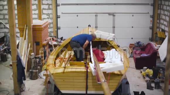 师傅在车间用新的木制自制船工作很宽视频的预览图