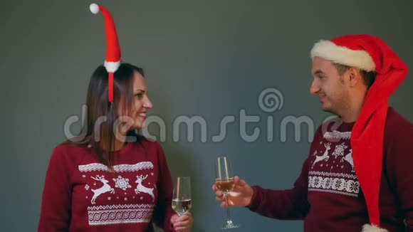 一对戴着圣诞帽的夫妇戴着香槟酒杯庆祝新年视频的预览图