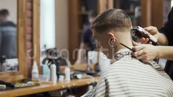发型师为理发店的年轻人做现代发型视频的预览图