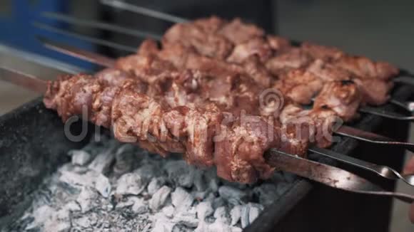 靠近烤架上的烹饪食物肉串上的肉慢动作视频的预览图
