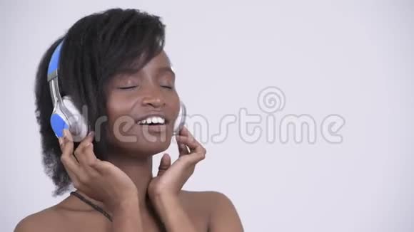 快乐年轻美丽的非洲女人听音乐视频的预览图