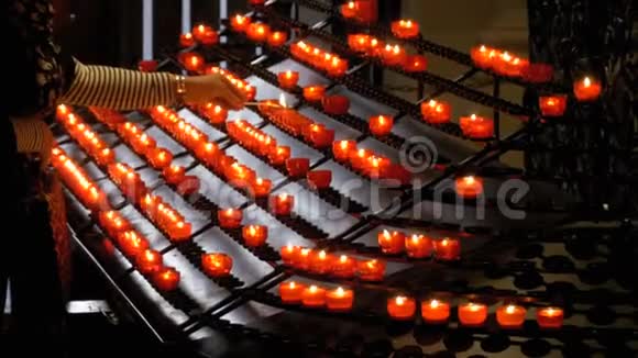 妇女在基督教会上放蜡烛圣殿里有许多蜡烛视频的预览图