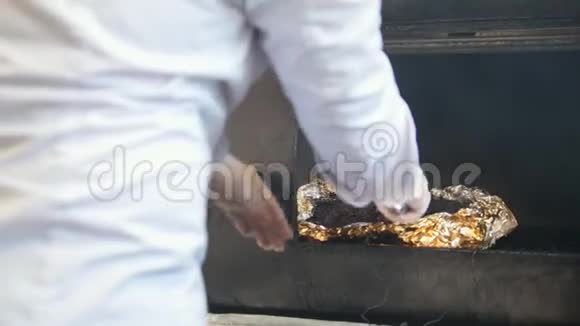 厨师在厨房的烤架上抽烟视频的预览图