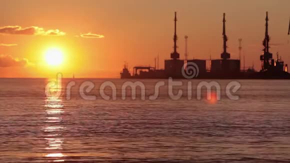 海港五彩缤纷的日落背景中的太阳落在地平线上视频的预览图