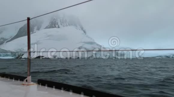游艇绕着南极洲的岩石海岸航行安德列夫视频的预览图
