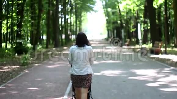 带着婴儿车在树林里散步的年轻女子视频的预览图