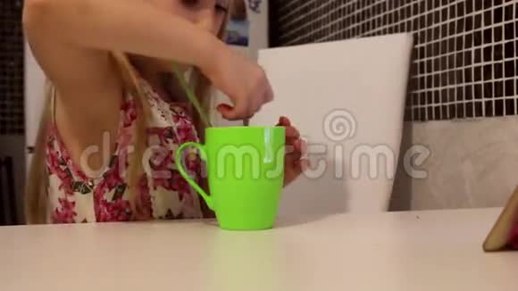 可爱的小女孩正在吃早餐孩子吃柠檬喝茶视频的预览图