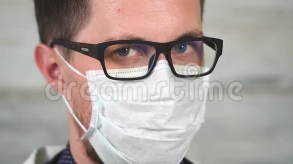 一个戴眼镜戴破布面具的年轻人的肖像视频的预览图