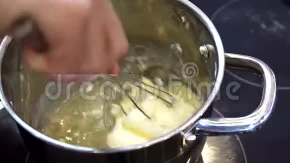 黄油在一个站在电炉上的锅里加热视频的预览图