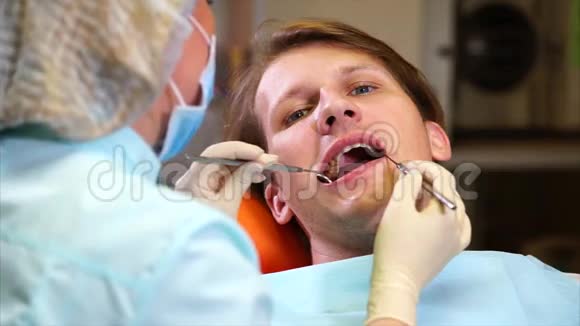 一位女牙医用牙镜检查病人的口腔视频的预览图