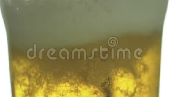 啤酒倒入玻璃上的孤立背景泡沫上升视频的预览图