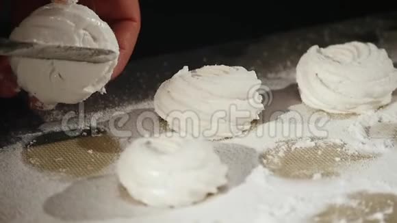 男人手洒糖霜用筛子做糖果洒在棉花糖上视频的预览图