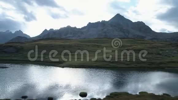 高山湖上方的空中一侧在阴天黄昏或黎明时露出山谷欧洲意大利阿尔卑斯山视频的预览图