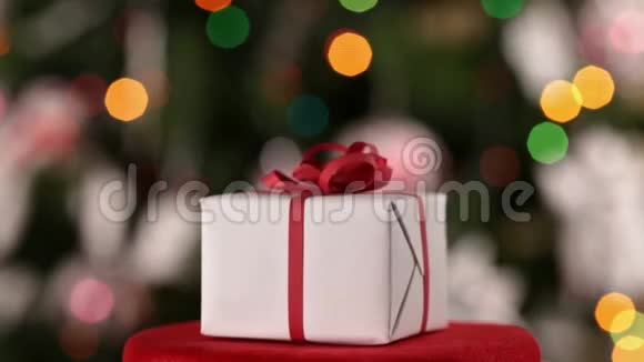 圣诞礼盒在装饰好的圣诞树前旋转视频的预览图