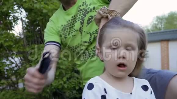 父亲给可爱的女孩做发型视频的预览图