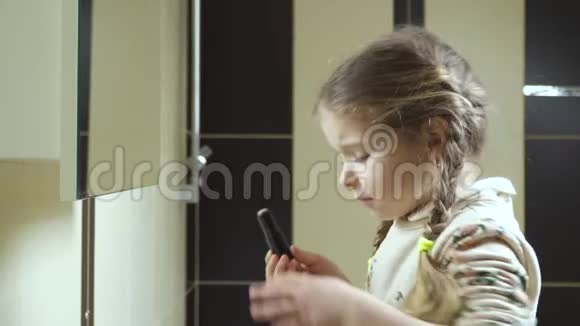 在镜子前涂口红的小女孩视频的预览图