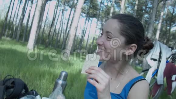 自然界中一个笑的年轻女人吃膳食食物一个快乐美丽的女孩吃一顿小卡路里的饭视频的预览图