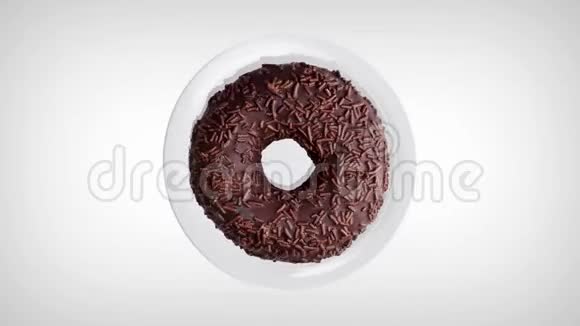 美味的巧克力甜甜圈在白色盘子上旋转甜甜圈特写顶部视图视频的预览图