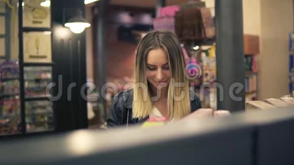 快乐的年轻女人在杂货店购物随便女人在超市里从货架上挑选食物微笑顾客视频的预览图