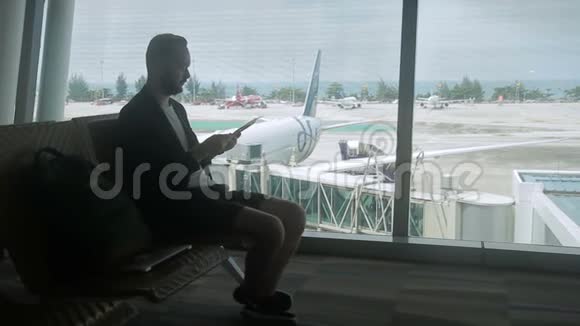 男旅行者正在机场等他的航班视频的预览图