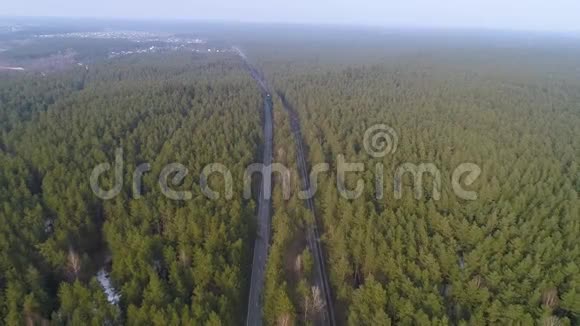 空中飞越森林之间的道路两条路中间的树木视频的预览图