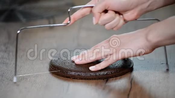 女人手工切割海绵蛋糕烹饪蛋糕特写镜头视频的预览图