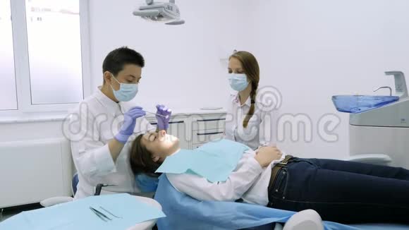 牙科医生用钻头和牙科镜进行治疗视频的预览图