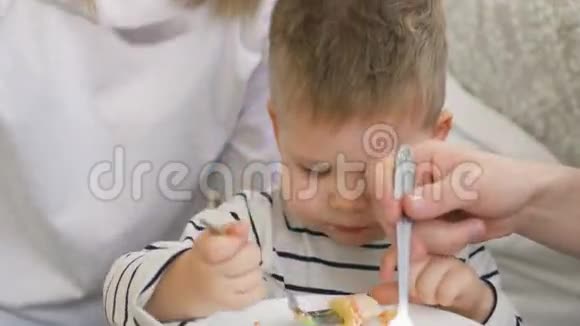 小可爱的男孩和爸爸妈妈一起庆祝生日吃蛋糕喝茶视频的预览图