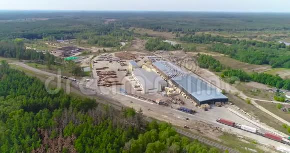 一个大型锯木厂位于森林地区的鸟瞰图现代化的木工工厂与铁路交汇处视频的预览图
