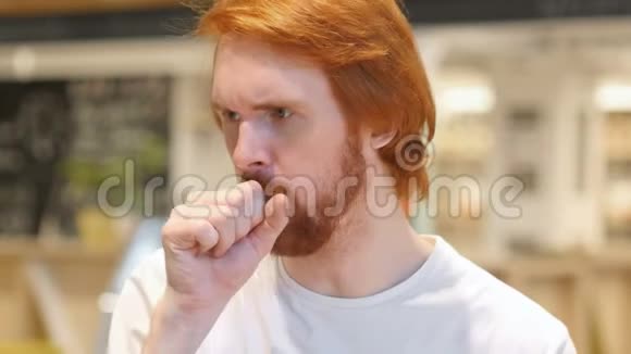 红头发胡须男咳嗽咽喉感染的肖像视频的预览图