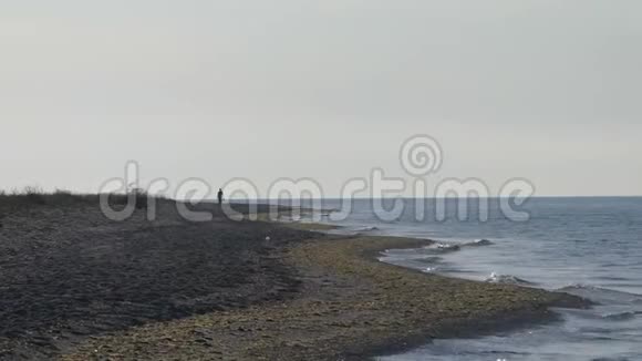 一位孤独的游客在黑海海滩散步视频的预览图
