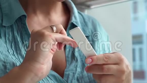 女性在家修指甲时用指甲文件归档指甲家美甲和美甲护理女人自己修指甲视频的预览图
