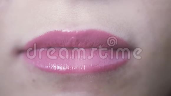 张开嘴和牙齿闭上年轻女孩美丽的粉红色嘴唇视频的预览图