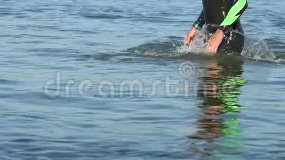 运动员游泳运动员从游泳到骑自行车在河上慢动作视频的预览图