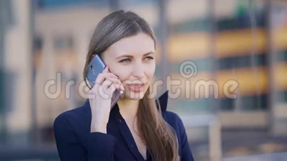 女商人在打电话自信的年轻女工站在办公楼里打电话视频的预览图