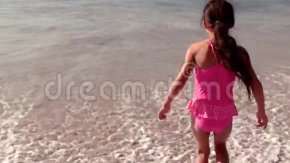 可爱的女孩朝海浪跑去视频的预览图