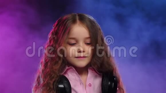 小女孩DJ在乙烯基上玩彩色烟雾慢动作视频的预览图