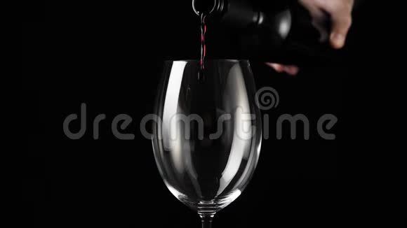 豪华红酒手从酒瓶中倒出美味的葡萄酒在黑暗的背景下倒入酒杯玫瑰酒视频的预览图