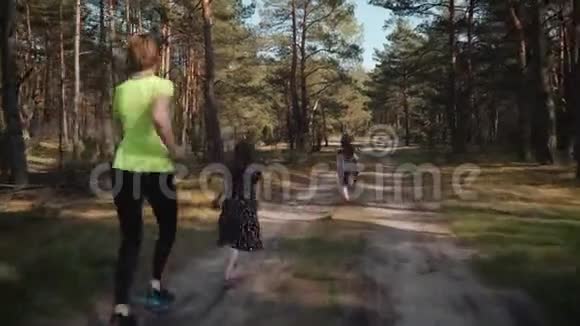 母亲和女儿正在夏天的森林里奔跑视频的预览图