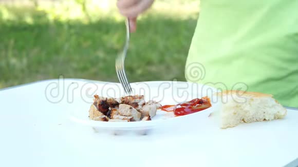 白色盘子的特写与什什烤肉串烧烤这孩子正在吃什什烤串在特写镜头中视频的预览图