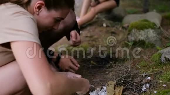 一个男人教一个女孩用打火石生火视频的预览图