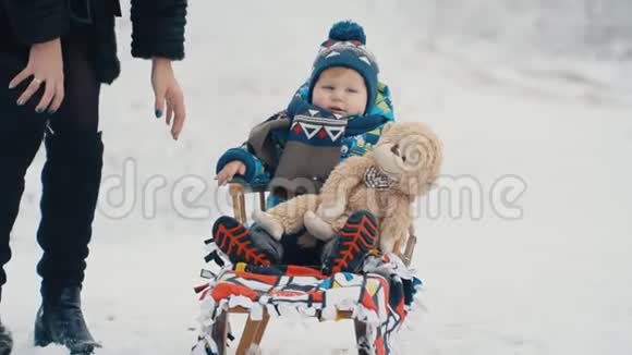 带雪橇的小男孩视频的预览图