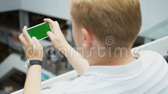 青少年在咖啡馆里玩智能手机游戏年轻快乐的人在智能手机上玩游戏智能手机开启视频的预览图