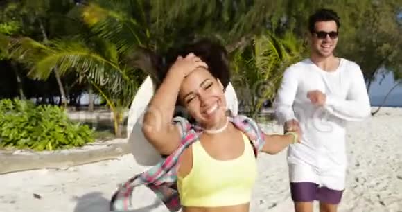 女孩牵着男人的手在海滩上奔跑快乐的微笑游客夫妇在海上度假视频的预览图