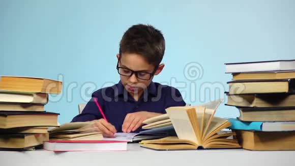 小男孩拿出一张张书蓝色背景慢动作视频的预览图