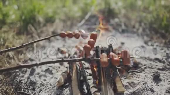 在篝火上烤脂肪香肠捷克农村流行的户外活动在篝火旁煮香肠视频的预览图