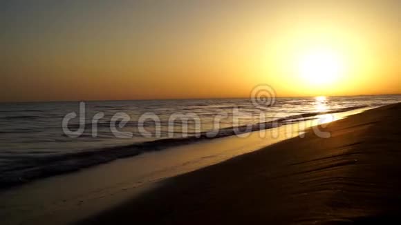 绚丽的时光流逝黄昏的夕阳天际线平静的令人满意的海浪拍打在沙滩海岸上视频的预览图
