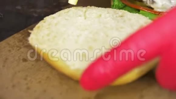 宏人在面包上倒入芥末用来煮汉堡视频的预览图