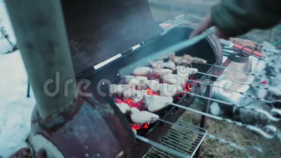鸡翅在烤架中煮熟同时挥动一个附件来保持温度慢动作视频的预览图